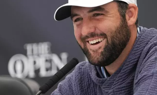 Scottie Scheffler of the United States reacts during a press conference ahead of the British Open Golf Championships at Royal Troon golf club in Troon, Scotland, Tuesday, July 16, 2024. (AP Photo/Mark Baker)