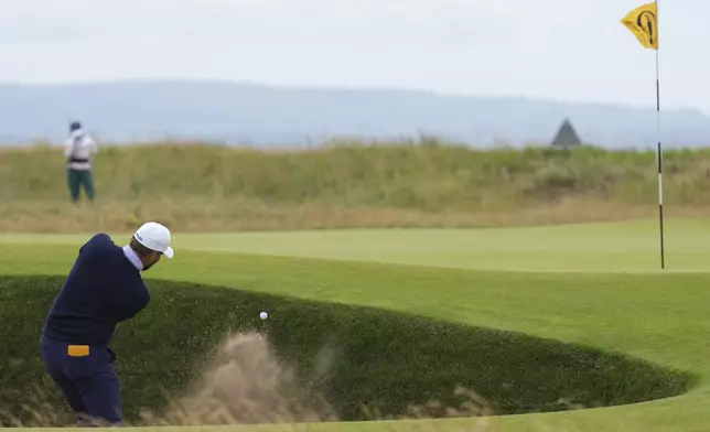 Daniel Brown of England plays from a bunker one the first hole during his final round of the British Open Golf Championships at Royal Troon golf club in Troon, Scotland, Sunday, July 21, 2024. (AP Photo/Jon Super)