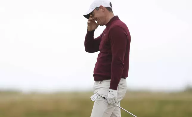 Rory McIlroy of Northern Ireland reacts after playing from the rough on the third hole during his second round of the British Open Golf Championships at Royal Troon golf club in Troon, Scotland, Friday, July 19, 2024. (AP Photo/Peter Morrison)