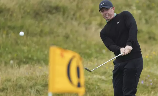 Rory McIlroy of Northern Ireland chips onto the fifth green during his opening round of the British Open Golf Championships at Royal Troon golf club in Troon, Scotland, Thursday, July 18, 2024. (AP Photo/Jon Super)