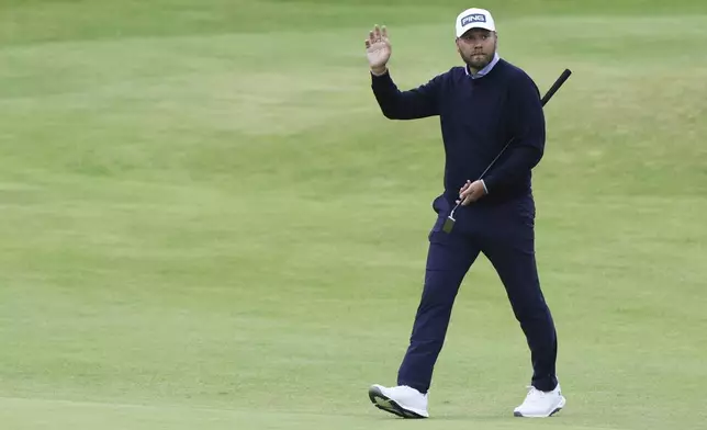 Daniel Brown of England gestures to the spectators as he walks to the 18th green during his final round of the British Open Golf Championships at Royal Troon golf club in Troon, Scotland, Sunday, July 21, 2024. (AP Photo/Scott Heppell)