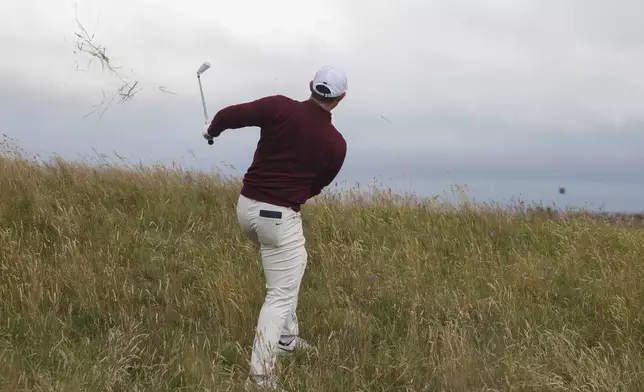 Rory McIlroy of Northern Ireland plays from the rough on the fourth hole during his second round of the British Open Golf Championships at Royal Troon golf club in Troon, Scotland, Friday, July 19, 2024. (AP Photo/Peter Morrison)