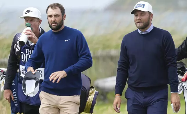 Daniel Brown, right, of England and Scottie Scheffler of the United States walk the second fairway together during their final round of the British Open Golf Championships at Royal Troon golf club in Troon, Scotland, Sunday, July 21, 2024. (AP Photo/Jon Super)