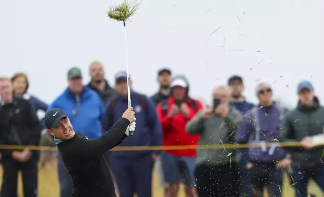 Rory McIlroy of Northern Ireland plays from the rough on the 15th hole during his opening round of the British Open Golf Championships at Royal Troon golf club in Troon, Scotland, Thursday, July 18, 2024. (AP Photo/Peter Morrison)