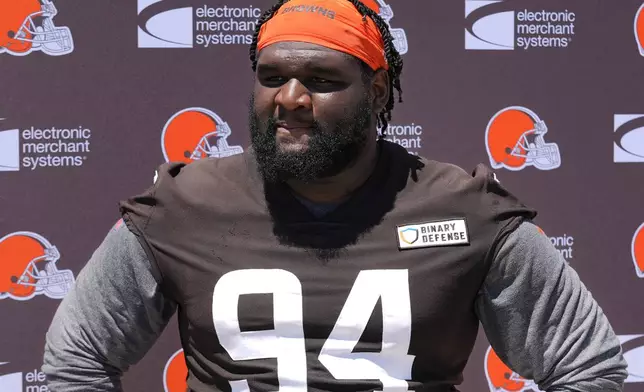 FILE - Cleveland Browns' Dalvin Tomlinson answers a question following an NFL football practice in Berea, Ohio, June 11, 2024. Tomlinson is scheduled to undergo an arthroscopic procedure on his knee Friday, July 26, 2024. (AP Photo/Sue Ogrocki, file)