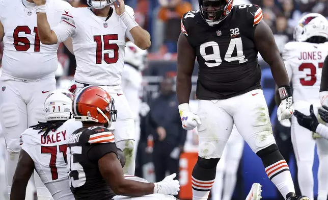 FILE - Cleveland Browns defensive tackle Dalvin Tomlinson (94) reacts after making a defensive stop during an NFL football game against the Arizona Cardinals, Sunday, Nov. 5, 2023, in Cleveland. Greg Newsome II has had surgery on an injured hamstring and Tomlinson is scheduled to undergo an arthroscopic procedure on his knee Friday, July 26, 2024. (AP Photo/Kirk Irwin, File)