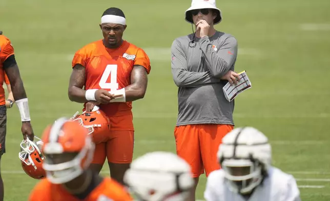 Cleveland Browns quarterback Deshaun Watson (4) and Ken Dorsey, right, offensive coordinator, watch during an NFL football training camp practice Saturday, July 27, 2024, in White Sulphur Springs, W.Va. (AP Photo/Sue Ogrocki)