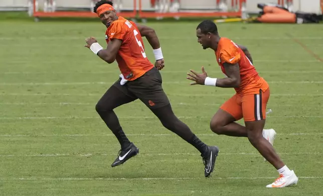 Cleveland Browns quarterbacks Jameis Winston, left, and Deshaun Watson, right, run during an NFL football training camp practice Saturday, July 27, 2024, in White Sulphur Springs, W.Va. (AP Photo/Sue Ogrocki)