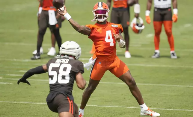 Cleveland Browns quarterback Deshaun Watson (4) passes under pressure from linebacker Jordan Hicks (58) during an NFL football training camp practice Friday, July 26, 2024, in White Sulphur Springs, W.Va., Saturday, July 27, 2024. (AP Photo/Sue Ogrocki)