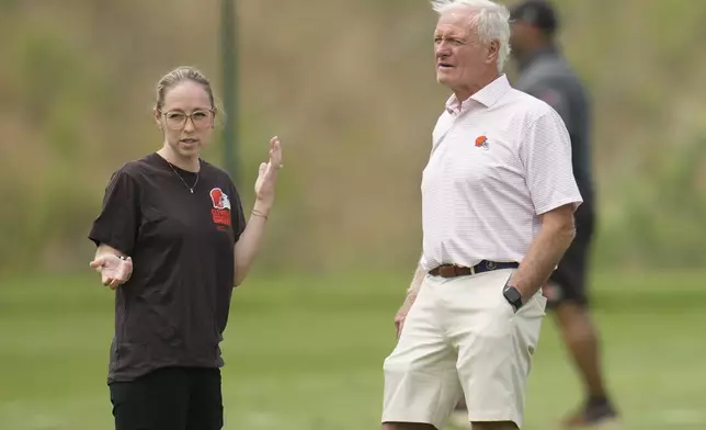 Cleveland Browns owner Jimmy Haslam, right, talks with Catherine Raiche, left, assistant general manager and vice president of football operations, during an NFL football training camp practice Saturday, July 27, 2024, in White Sulphur Springs, W.Va. (AP Photo/Sue Ogrocki)