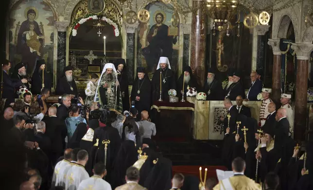 The newly elected Bulgarian Patriarch Daniil holds a cross after his enthronement ceremony at Alexander Nevsky Cathedral in Sofia, Bulgaria, Sunday, June 30, 2024. Bulgaria's Orthodox Church on Sunday elected Daniil, a 52-year-old metropolitan considered to be pro-Russian, as its new leader in a disputed vote that reflects the divisions in the church and in the society. (AP Photo/Valentina Petrova)