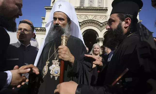 People greet the newly elected Bulgarian Patriarch Daniil after his enthronement ceremony at Alexander Nevsky Cathedral in Sofia, Bulgaria, Sunday, June 30, 2024. Bulgaria's Orthodox Church on Sunday elected Daniil, a 52-year-old metropolitan considered to be pro-Russian, as its new leader in a disputed vote that reflects the divisions in the church and in the society. (AP Photo/Valentina Petrova)