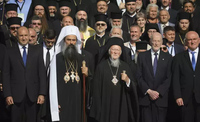 Istanbul-based Ecumenical Patriarch Bartholomew I, center, the spiritual leader of the world's Orthodox Christians, poses next to the newly elected Bulgarian Patriarch Daniil during a family photo after his enthronement ceremony at Alexander Nevsky Cathedral in Sofia, Bulgaria, Sunday, June 30, 2024. Bulgaria's Orthodox Church on Sunday elected Daniil, a 52-year-old metropolitan considered to be pro-Russian, as its new leader in a disputed vote that reflects the divisions in the church and in the society. (AP Photo/Valentina Petrova)