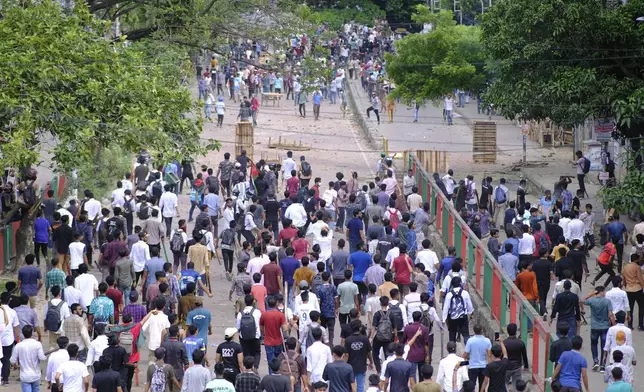 CORRECTS LOCATION - Students clash over quota system at New market area of Dhaka, Bangladesh, Tuesday, July 16, 2024. Police have fired tear gas and charged with batons overnight during violent clashes between a pro-government student body and student protesters, leaving dozens injured at a leading public university outside Bangladesh's capital over quota system in government jobs, police and students said Tuesday. (AP Photo/Mahmud Hossain Opu)