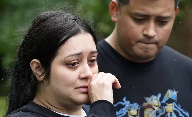 CORRECTION CORRECTS NAME Haley Loredo with her brother, Elmer Alvarado, wipes away tears outside her home in the 17400 block of Rustic Canyon Trail where her mother-in-law, Maria Loredo, 74, died after a tree fell on her second story bedroom during Hurricane Beryl, Monday, July 8, 2024, in Houston. (Melissa Phillip/Houston Chronicle via AP)