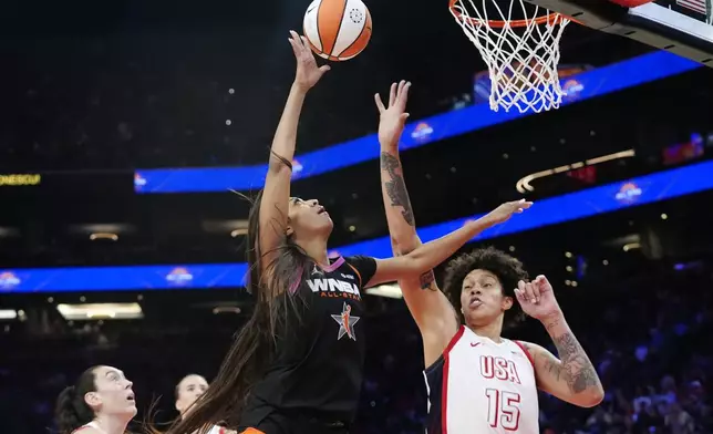 CORRECTS TO REESE NOT REECE - Angel Reese, second from right, of Team WNBA, shoots over Brittney Griner (15), of Team USA, during the second half of a WNBA All-Star basketball game Saturday, July 20, 2024, in Phoenix. (AP Photo/Ross D. Franklin)