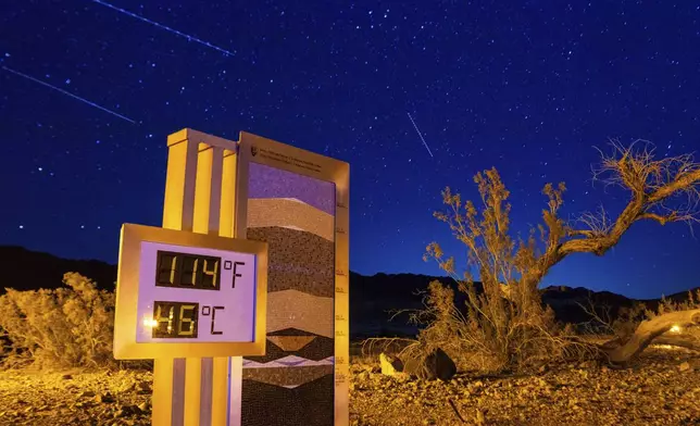 A long exposure image of the thermostat at the Furnace Creek Visitors Center taken just after 10:00 p.m., in Death Valley National Park, Calif., Sunday, July 7, 2024. Forecasters say a heat wave could break previous records across the U.S., including in Death Valley. (AP Photo/Ty ONeil)