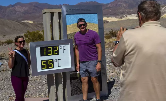 Melissa Bolding and Bryan Bolding from Oklahoma City pose for a photo next to a thermometer displaying a temperature of 132 degrees Fahrenheit / 55 degrees Celsius at the Furnace Creek Visitors Center, in Death Valley National Park, Calif., Sunday, July 7, 2024. Forecasters said a heat wave could break previous records across the U.S., including at Death Valley. (AP Photo/Ty ONeil)