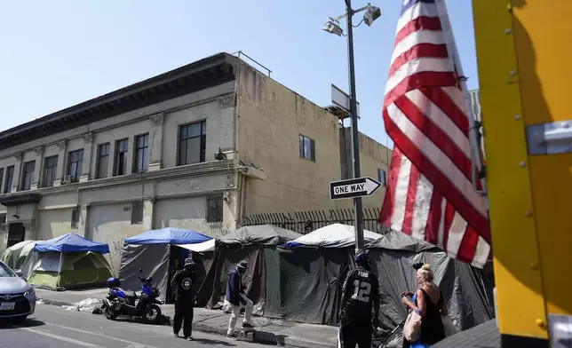 Tents are setup on a sidewalk, Thursday, July 25, 2024, in Los Angeles. California Gov. Gavin Newsom issued an executive order Thursday to direct state agencies on how to remove homeless encampments, a month after a Supreme Court ruling allowing cities to enforce bans on sleeping outside in public spaces. (AP Photo/Jae C. Hong)