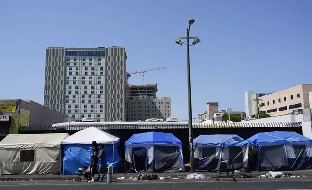 Tents are lined up on Skid Row Thursday, July 25, 2024, in Los Angeles. California Gov. Gavin Newsom issued an executive order Thursday to direct state agencies on how to remove homeless encampments, a month after a Supreme Court ruling allowing cities to enforce bans on sleeping outside in public spaces. (AP Photo/Jae C. Hong)