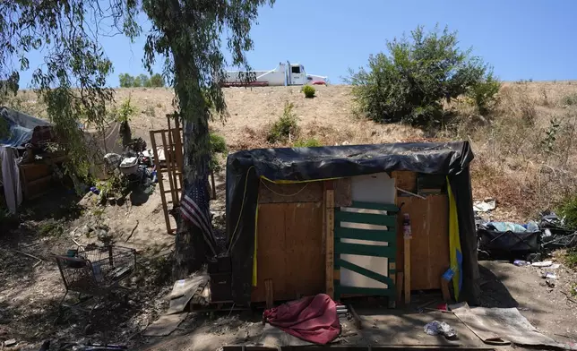 A homeless encampment is set up along the 405 Freeway in the Van Nuys section of Los Angeles on Friday, July 26, 2024, in Los Angeles. California Gov. Gavin Newsom has issued an executive order directing state agencies "to move urgently to address dangerous" homeless encampments and clear them from state land while giving city and local leaders a push to do the same. (AP Photo/Jae C. Hong)