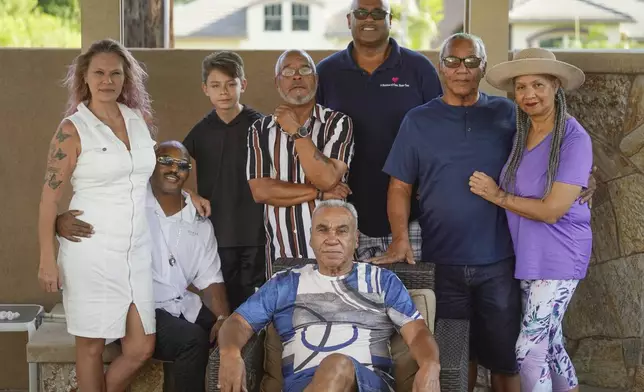 Descendants of Nelson Bell, from left: Tami More, with husband Trent Mure, and son, Armani, William Woolery, Louie Hoops and brothers, Milford Fonza, sitting center, and Elmer Fonza with wife, Carolyn, pose for a picture in Glendora, Calif., on Friday, Sept. 8, 2023. (AP Photo/Damian Dovarganes)