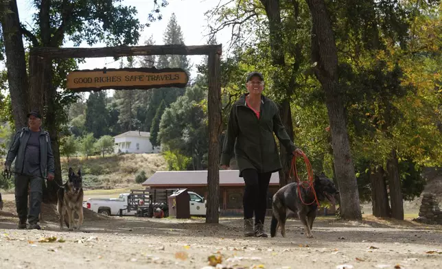 People walk through Marshall Gold Discovery State Historic Park, Tuesday, Oct. 10, 2023, in Coloma, Calif. (AP Photo/Godofredo A. Vásquez)