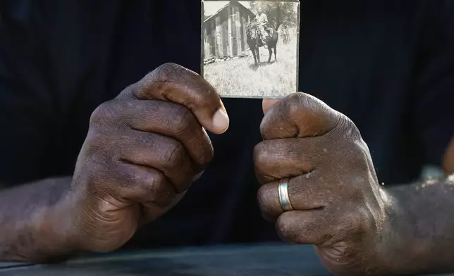 Matthew Burgess holds a photograph of his grandfather Rufus Morgan Burgess Jr., Monday, Oct. 9, 2023, in Sacramento, Calif. (AP Photo/Godofredo A. Vásquez)