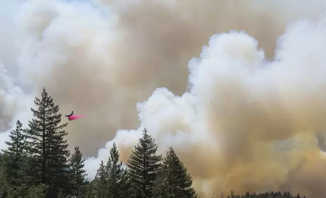 A plane drops fire retardant on the Park Fire near Forest Ranch, Calif., Sunday, July 28, 2024. (AP Photo/Nic Coury)