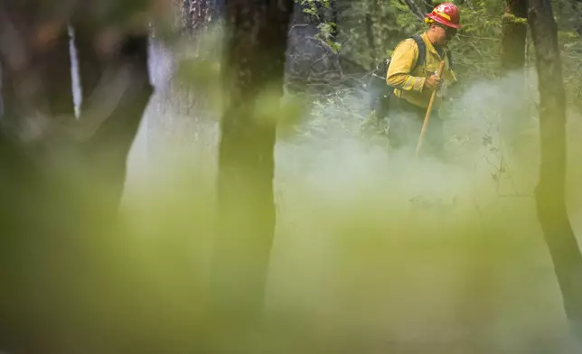 A firefighter monitors the Park Fire near Forest Ranch, Calif., Saturday, July 27, 2024. (AP Photo/Nic Coury)