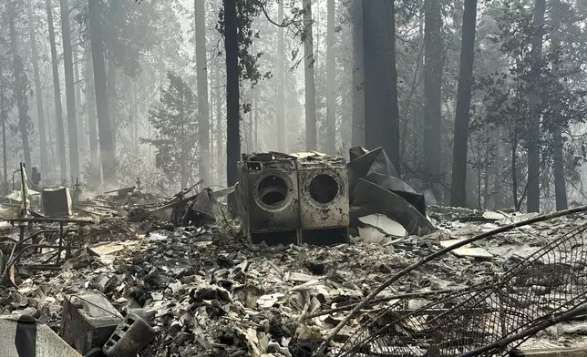 A property damaged by wildfire is seen in the aftermath of the Park Fire, Sunday, July 28, 2024, in the Cohasset community of Butte County, Calif. (AP Photo/Eugene Garcia)