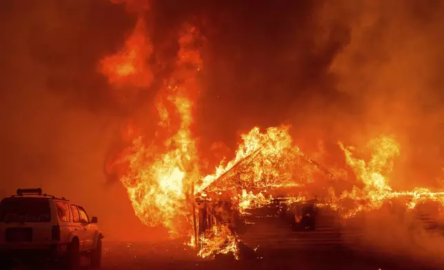 Flames consume a building as the Park Fire tears though the Cohasset community in Butte County, Calif., on Thursday, July 25, 2024. (AP Photo/Noah Berger)