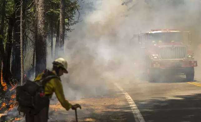 A Beckwourth Hot Shot monitors a burn operation along Highway 32 to help fight the Park Fire near Forest Ranch, Calif., Sunday, July 28, 2024. (AP Photo/Nic Coury)