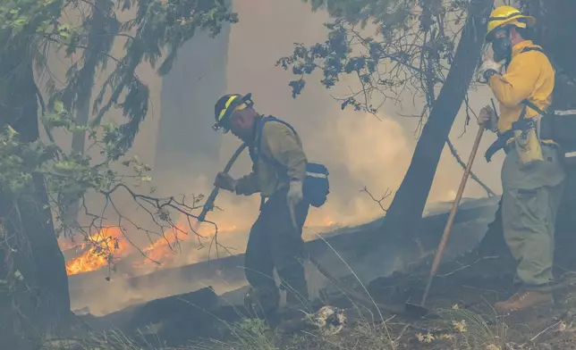 Fire crews battle the Park Fire along Highway 32 near Forest Ranch, Calif., Sunday, July 28, 2024. (AP Photo/Nic Coury)