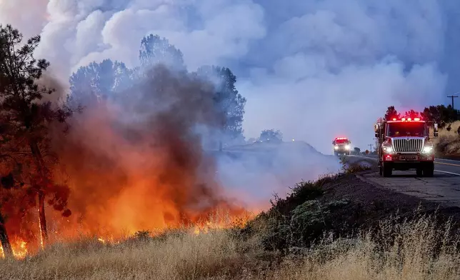 The Park Fire burns along Highway 32 in the Forest Ranch community of Butte County, Calif., on Thursday, July 25, 2024. (AP Photo/Noah Berger)