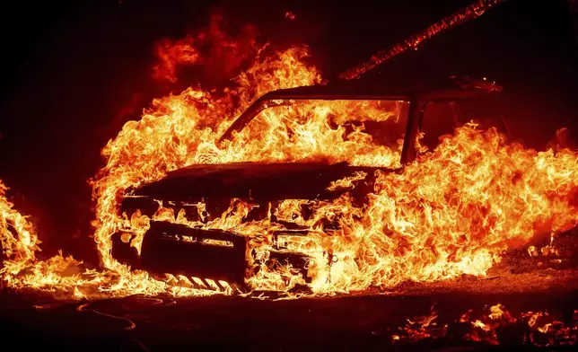 Flames consume a vehicle as the Park Fire jburns in Tehama County, Calif., on Friday, July 26, 2024. (AP Photo/Noah Berger)