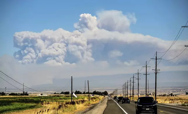 A plume rises from the Park Fire burning near Chico, Calif., on Thursday, July 25, 2024. (AP Photo/Noah Berger)