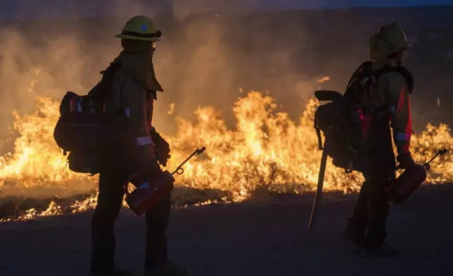 Fire crews light a burn operation along Highway 36 to slow the Park Fire near Dales, Calif., Monday, July 29, 2024. (AP Photo/Nic Coury)