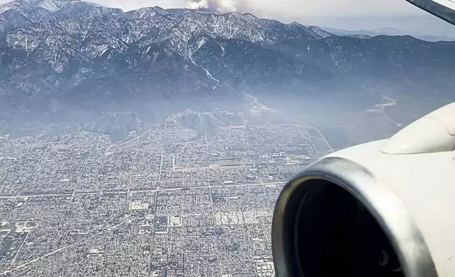 Smoke rises from the Vista fire as seen from a flight into Los Angeles International Airport on Tuesday, July 9, 2024, over Los Angeles. (AP Photo/Corinne Chin)