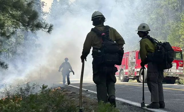 Fire crews monitor a backburn, Sunday, July 28, 2024, in the Butte Meadows area in Butte County, Calif. (AP Photo/Eugene Garcia)