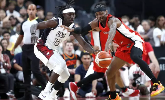 United States guard Jrue Holiday (12) and Canada guard Shai Gilgeous-Alexander (2) vie for the ball during the first half of an exhibition basketball game Wednesday, July 10, 2024, in Las Vegas. (AP Photo/Steve Marcus)