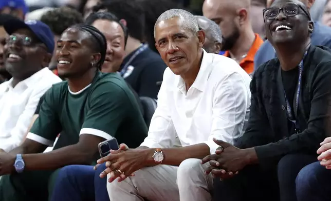 Former U.S. President Barack Obama, center, watches an exhibition basketball game between the United States and Canada, Wednesday, July 10, 2024, in Las Vegas. (AP Photo/Steve Marcus)