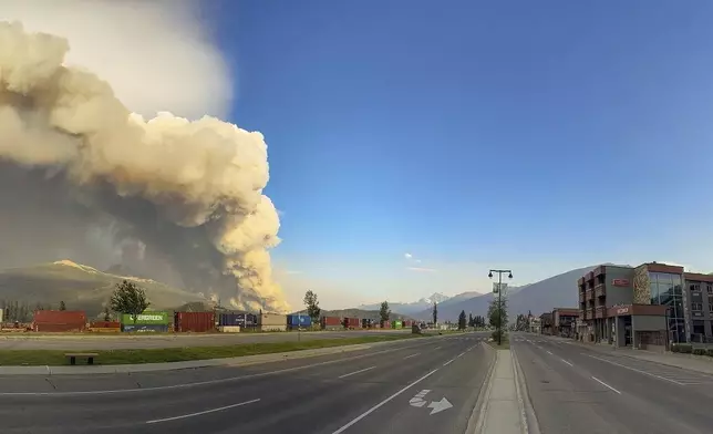 In this photo released by the Jasper National Park, smoke rises from a wildfire burning near Jasper, Alberta, Canada, Wednesday, July 24, 2024. (Jasper National Park via The Canadian Press via AP)