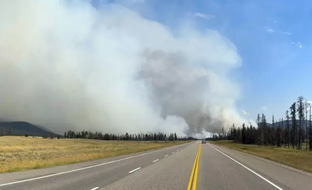 In this photo released by the Jasper National Park, smoke rises from a wildfire burning near Jasper, Alberta, Canada, Wednesday, July 24, 2024. (Jasper National Park/The Canadian Press via AP)