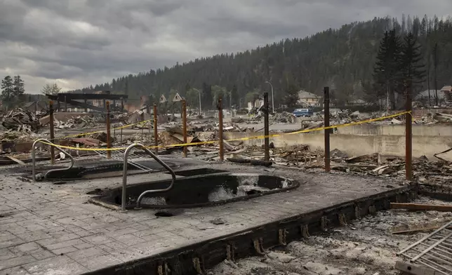 The remains of a hotel is seen in Jasper, Alta., on Friday July 26, 2024. Wildfires encroaching into the townsite of Jasper forced an evacuation of the national park. (Amber Bracken/The Canadian Press via AP)