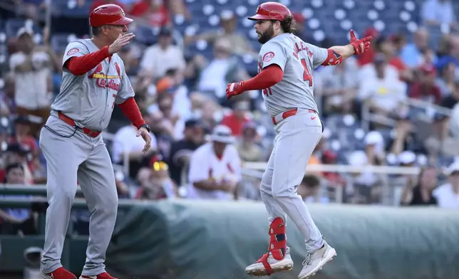 St. Louis Cardinals' Alec Burleson, right, celebrates after his home run with third base coach Ron "Pop" Warner, left, during the eighth inning of a baseball game against the Washington Nationals, Monday, July 8, 2024, in Washington. (AP Photo/Nick Wass)