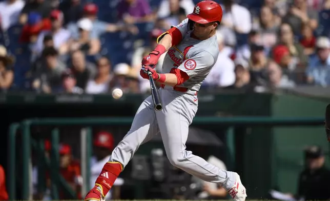 St. Louis Cardinals' Lars Nootbaar hits a single during the fourth inning of a baseball game against the Washington Nationals, Monday, July 8, 2024, in Washington. (AP Photo/Nick Wass)