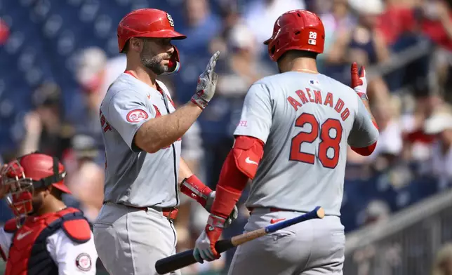 St. Louis Cardinals' Paul Goldschmidt, left, celebrates his home run with Nolan Arenado (28) during the fourth inning of a baseball game against the Washington Nationals, Monday, July 8, 2024, in Washington. (AP Photo/Nick Wass)