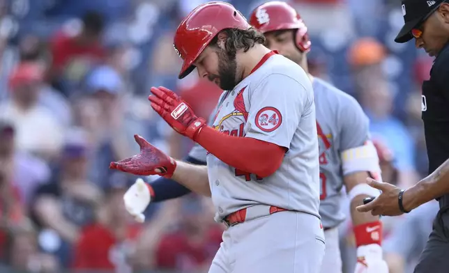 St. Louis Cardinals' Alec Burleson, left, celebrates after his home run during the eighth inning of a baseball game against the Washington Nationals, Monday, July 8, 2024, in Washington. (AP Photo/Nick Wass)