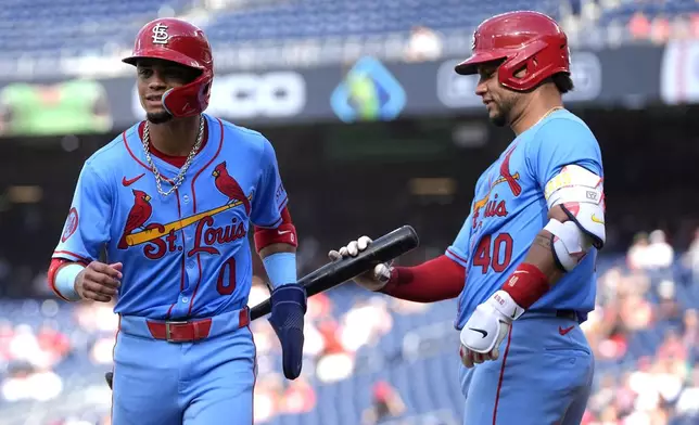 St. Louis Cardinals' Masyn Winn (0), left, is congratulated by Willson Contreras (40) after scoring on a wild pitch during the fourth inning of a baseball game against the Washington Nationals at Nationals Park, Saturday, July 6, 2024, in Washington. (AP Photo/Mark Schiefelbein)